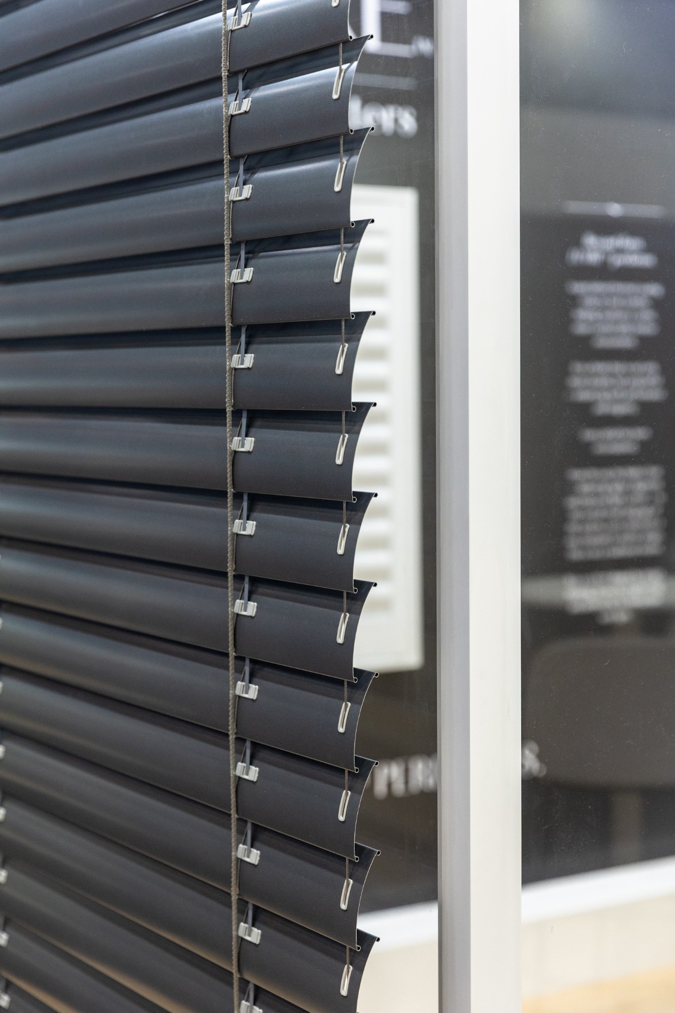 Close detail of dark external aluminium venetian slats and side fittings