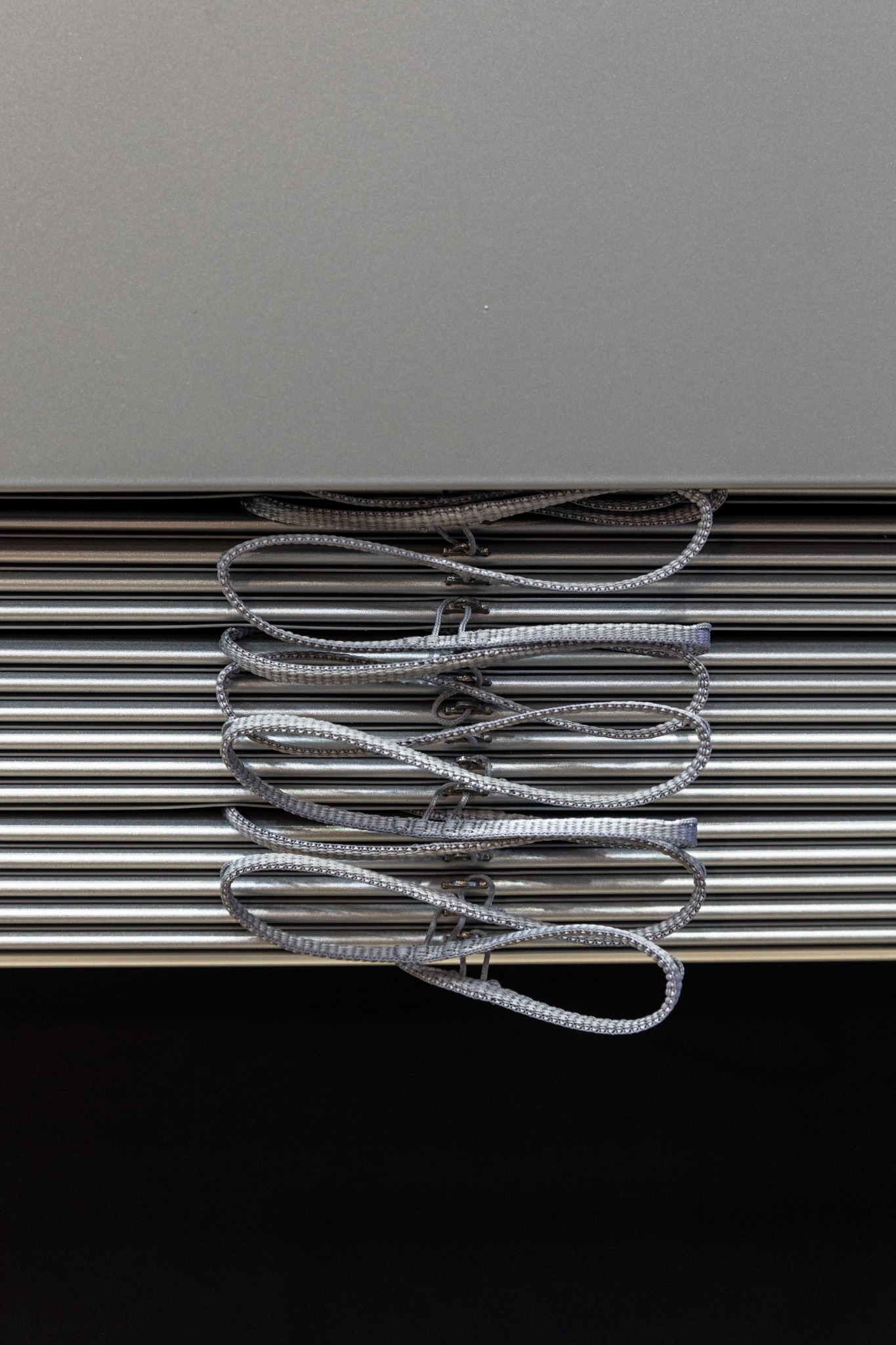 External aluminium venetian slats stacked beneath their headbox